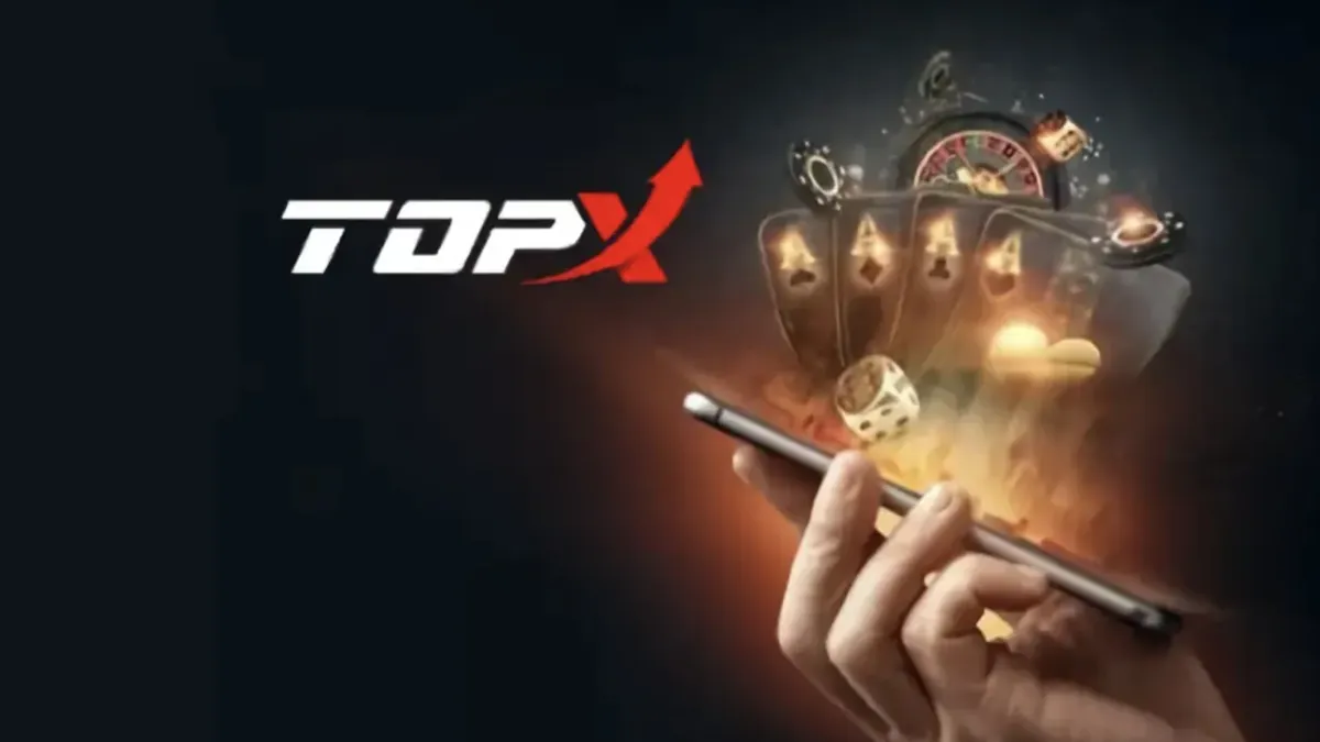 Mão segurando um celular diante de uma tela escura, representando falha de login na TopX